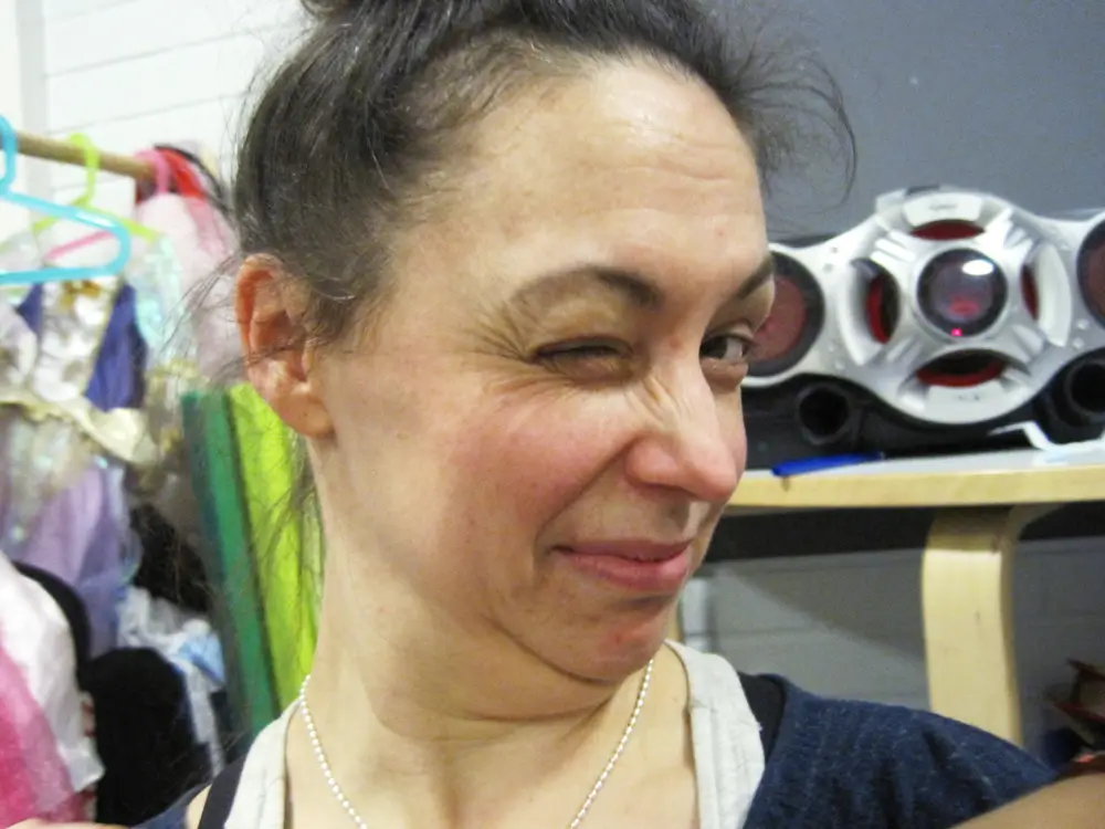 A collage of two photographs of the researcher, in which she is making funny faces for the children.